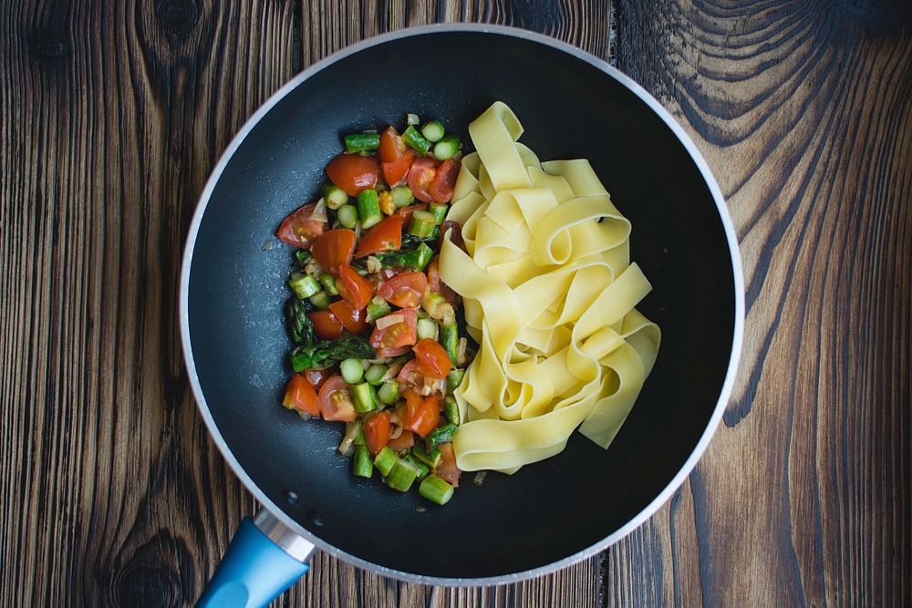 Tagliatelle with asparagus and tomatoes in pan food photography