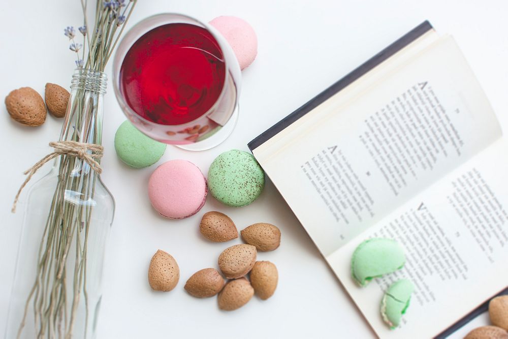 Pink and green macaroons and a book on the table
