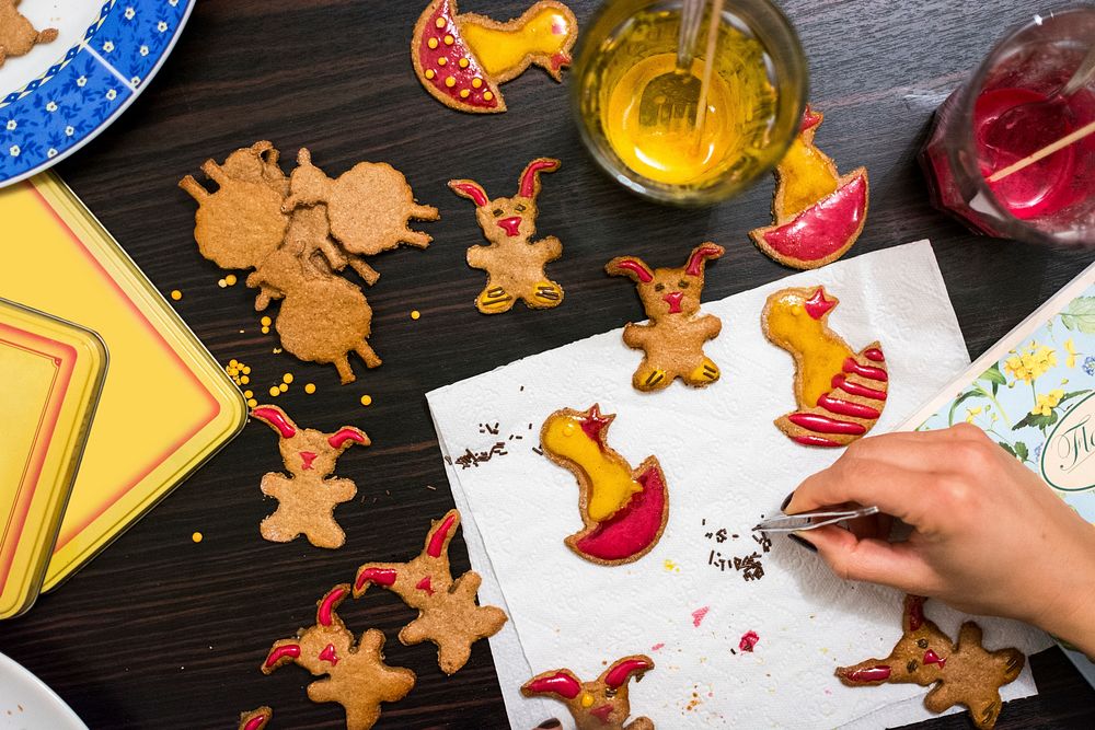 Woman decorating Easter gingerbread food photography