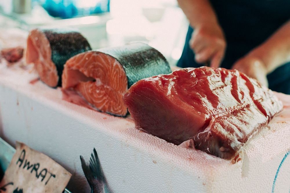 Seller slicing fish fillet