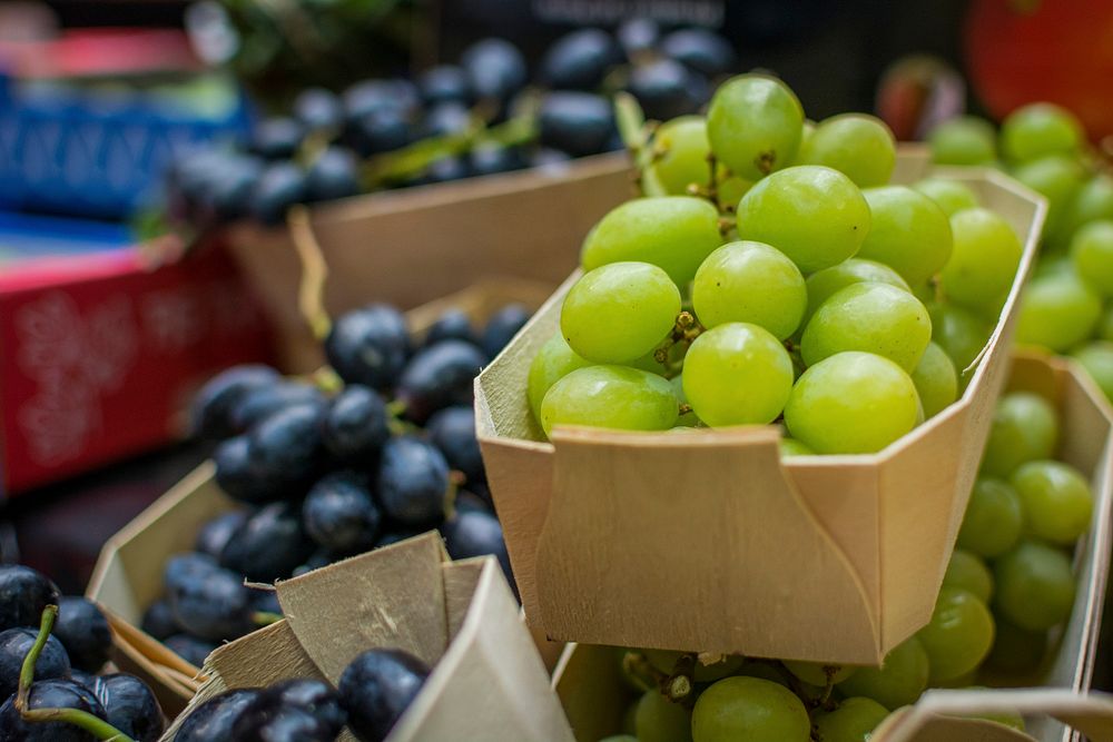 Green and black grapes at a market