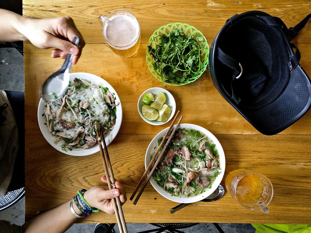 Eating Pho Bo, a Vietnamese noodle soup