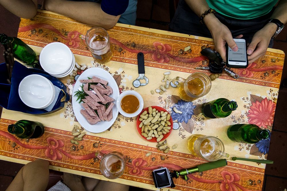 Enjoying Vietnamese beer and snacks