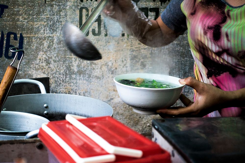 A seller preparing Pho, a Vietnamese noodle soup