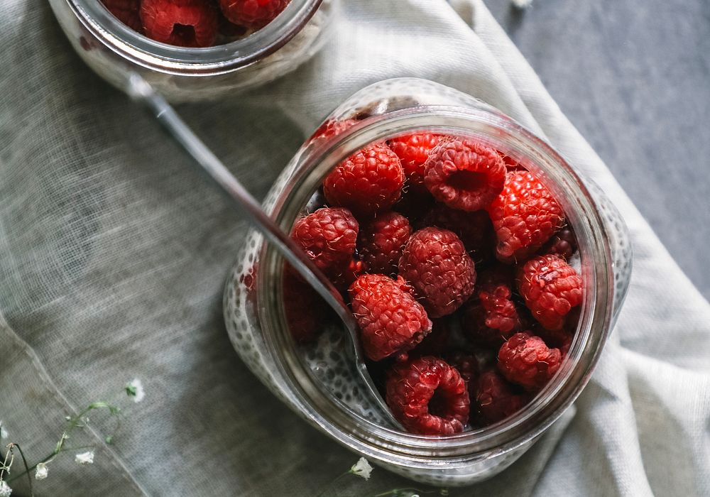Fresh raspberry in jars