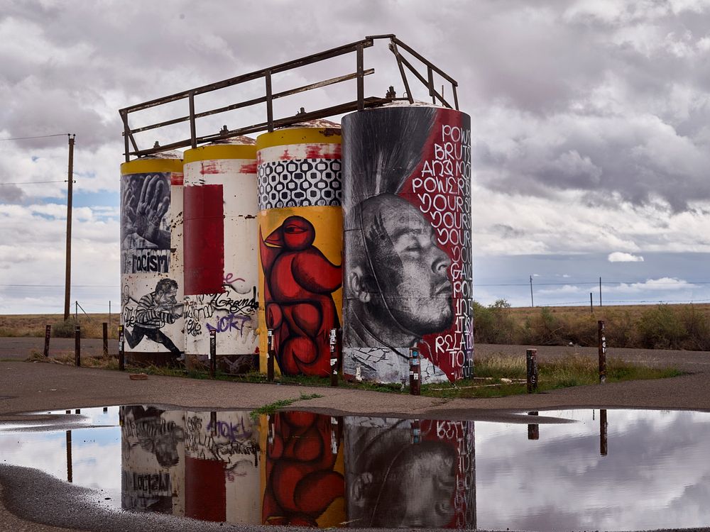 Artwork on water towers along a remote Arizona road leading to Monument Valley Navajo Tribal Park, a red-sand desert region…