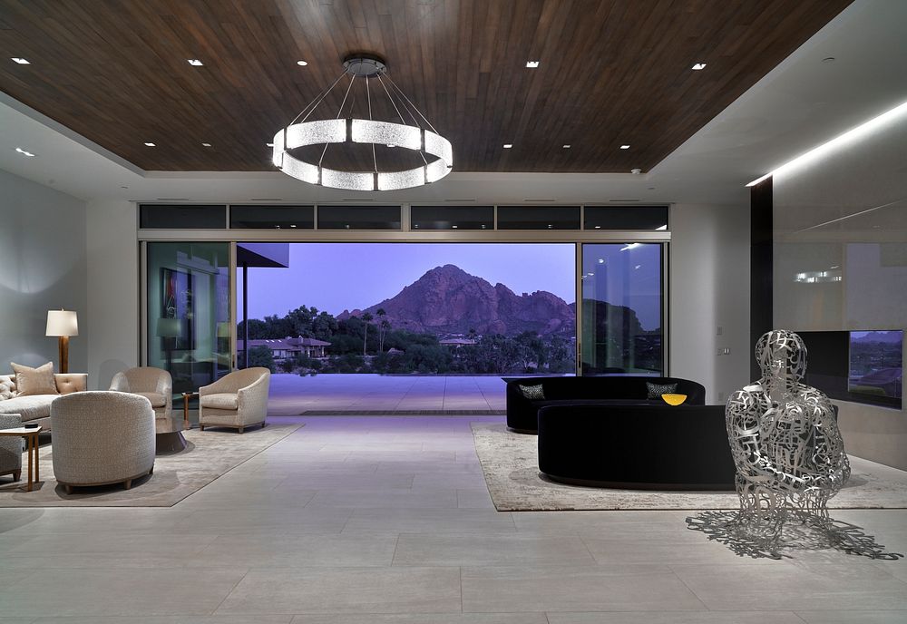 The wide doorway of the living room in an elegant, modernist house in the prosperous community of Paradise Valley, Arizona…