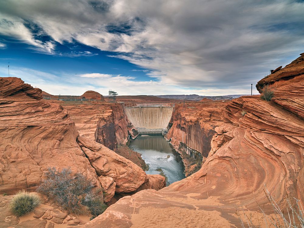 View from a bend in the Colorado River of Glen Canyon Dam, outside Page, Arizona. Original image from Carol M.…