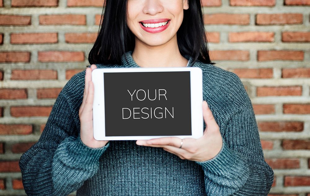 Smiling woman holding an empty screen tablet