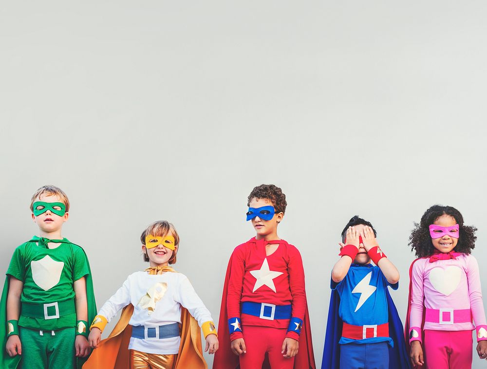 Smiling diverse children in superhero costumes