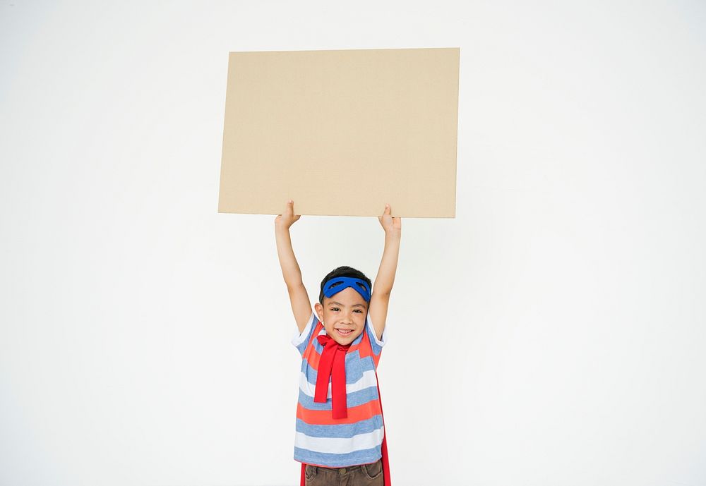 Smiling superhero kid holding up an empty placard