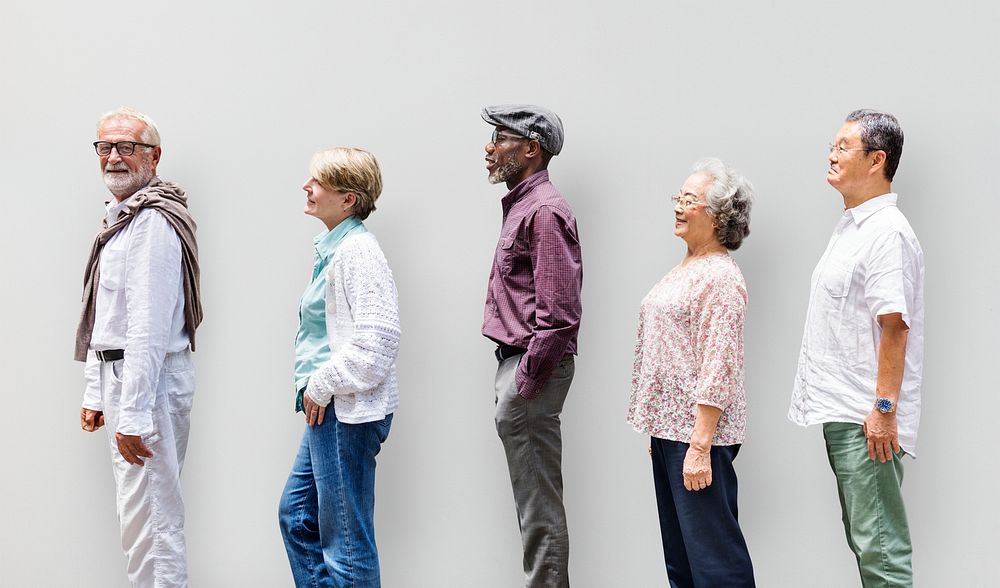 Diverse senior adults standing in a row sideways