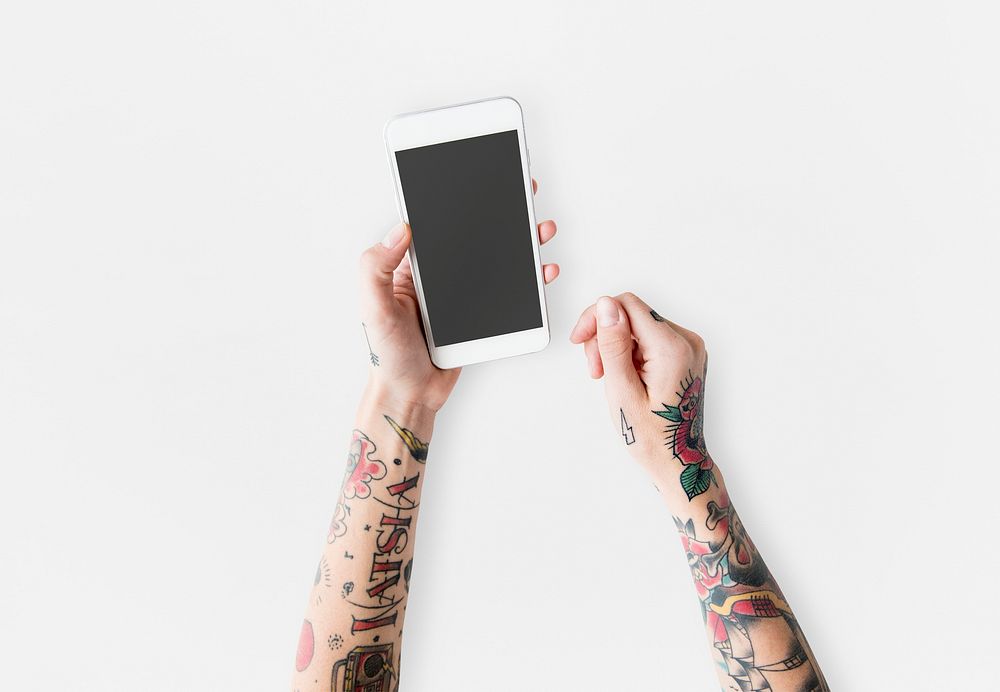 Tattooed ands holding a mobile phone