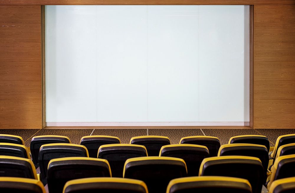 Empty conference room with a white screen