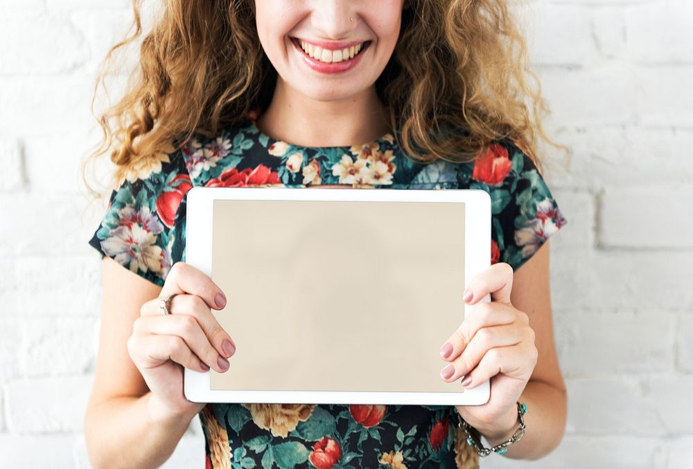 Caucasian woman holding digital tablet