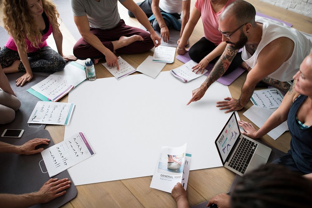 Yoga people discussing poses in a circle