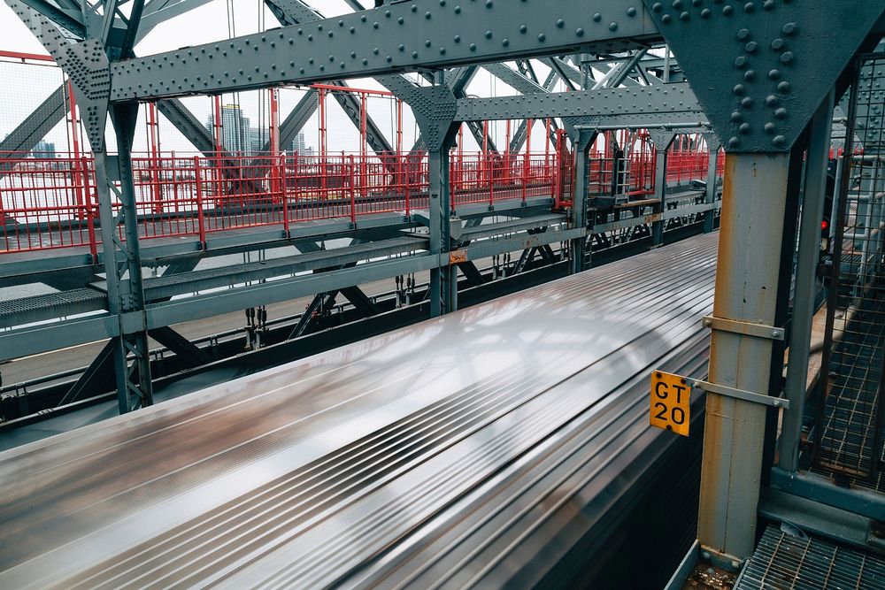 Free looking down at the roof of a subway as it drives across a bridge image, public domain CC0 photo.