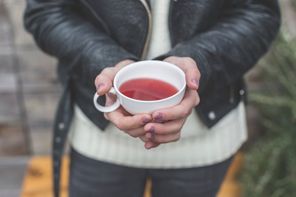 Free woman hands holding pink herbal tea cup photo, public domain beverage CC0 image.