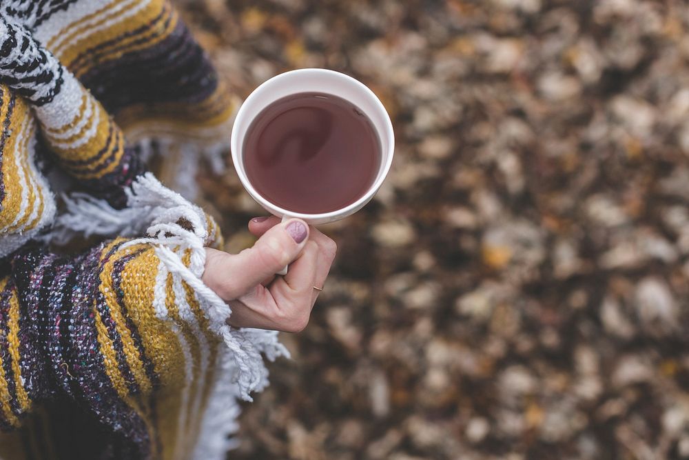 Free hand holding a cup of coffee photo, public domain drink CC0 image.