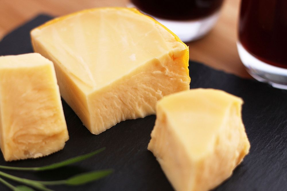 Free close up of cheese on a black slate image, public domain food CC0 photo.