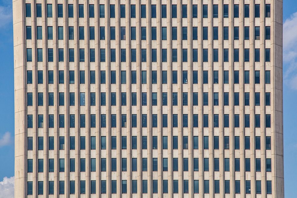 View of a tan building full of windows.