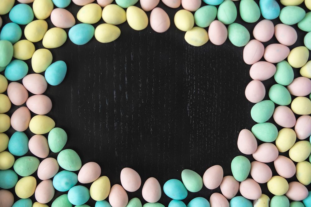 Colorful Easer mini eggs make a border around an open table space, where you can add your own text.