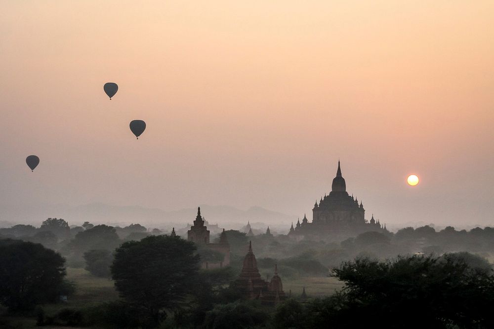Hot air balloons floating in Myanmar skyline during a foggy sunset. Free public domain CC0 photo.