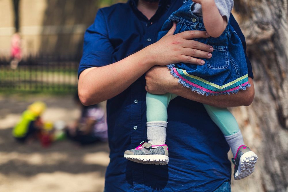 Father carrying daughter in a park, free public domain CC0 image.