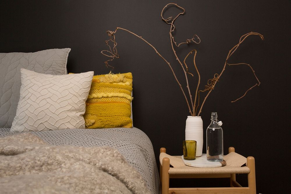 A guest room is set up with water on the bedside table and warm blankets on the bed, free public domain CC0 image.