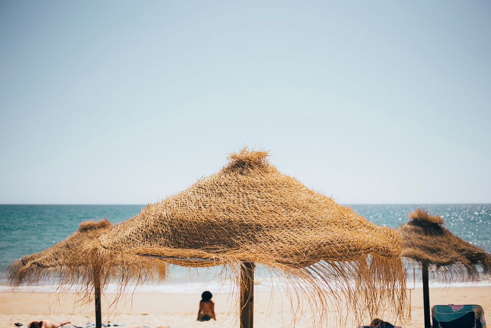 Free beach shades by the seaside public domain CC0 photo.