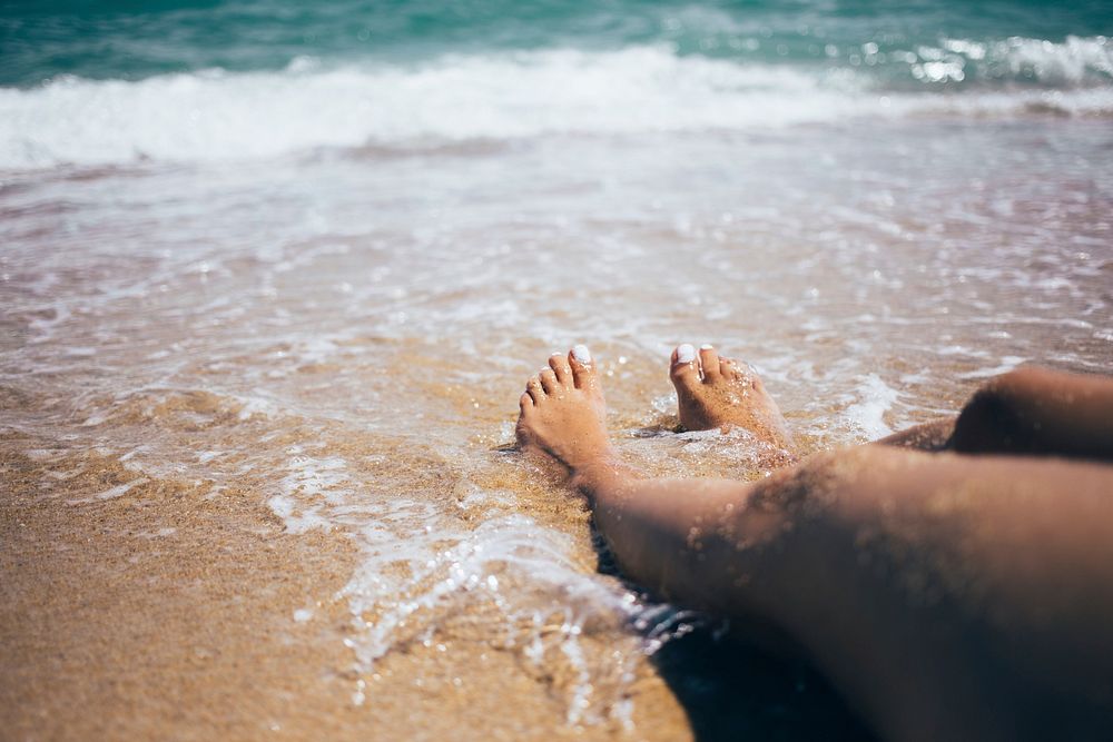 Free wave touching woman feet public domain CC0 photo.