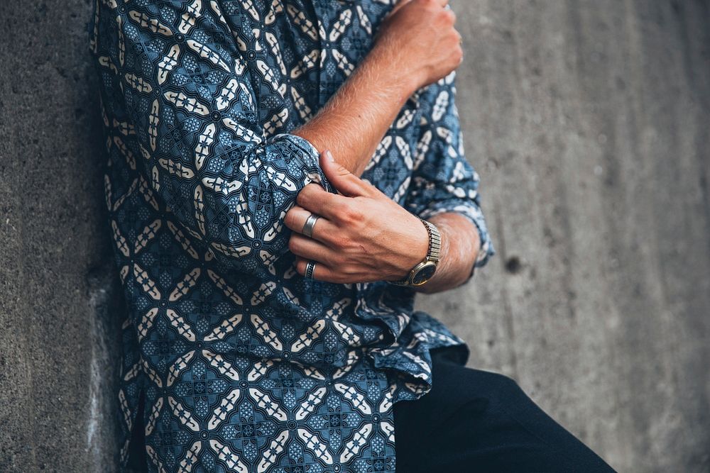 Free man in a blue shirt adjusting his sleeve, public domain people CC0 photo.