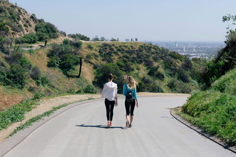 Two female friends walking back home after a hike up the Hollywood hills.