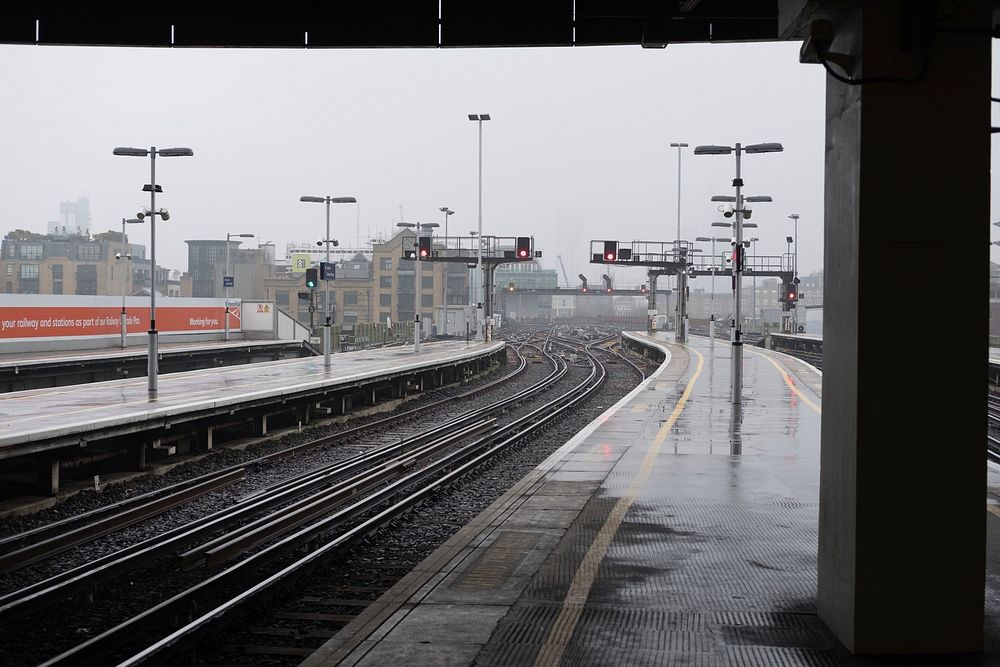 Free train tracks and signals stand in the railyard on a rainy and foggy day image, public domain CC0 photo.