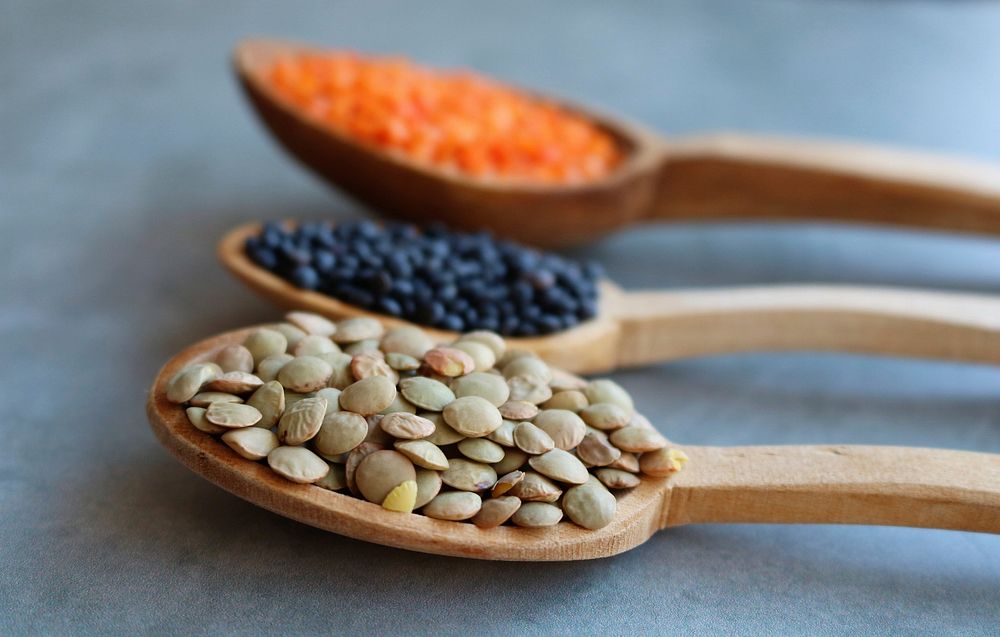 Free lentils in wooden spoon, three colors image, public domain CC0 beans photo.