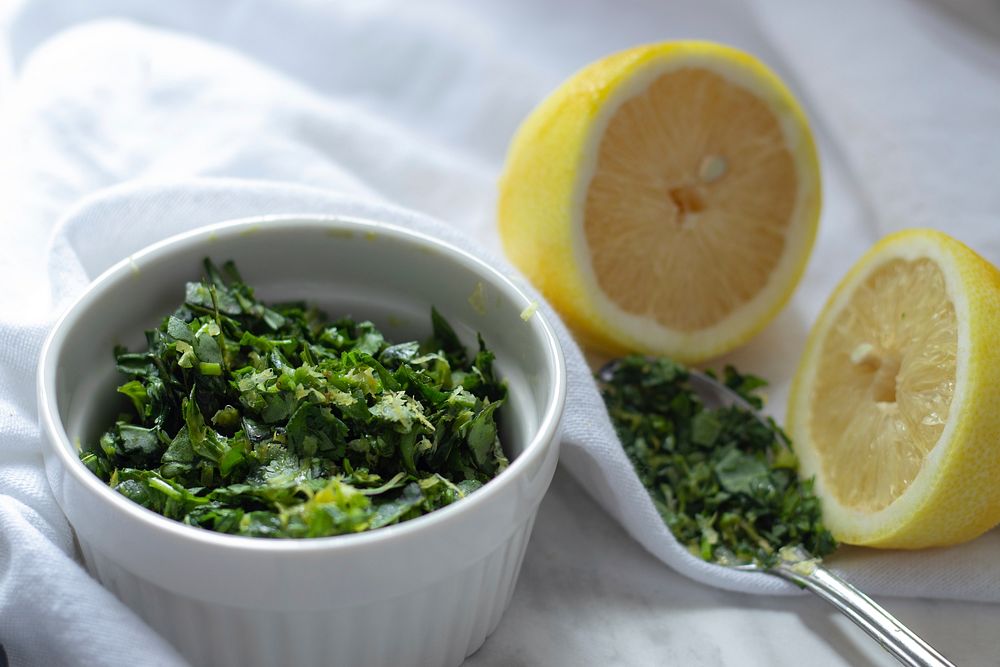 Free green herb chopped up in bowl with lemon on table photo, public domain food CC0 image.