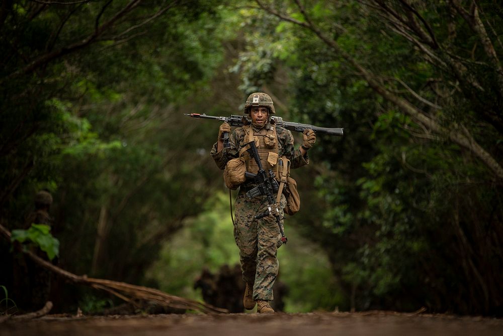 U.S. Marine Corps Lance Cpl. Marc Mercado, assigned to the Advanced Infantry Marine Course (AIMC), carries an M240B machine…