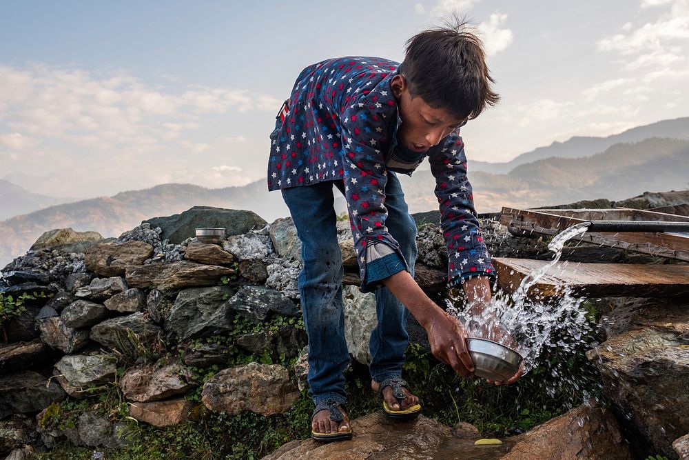 Nepali boy holding water dipper, Kailas, Bajhang District, Nepal, October 2017.