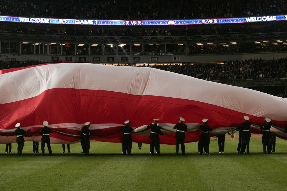 World Series, Game 1Marines, sailors, airmen, soldiers and West Point cadets unfurl an outfield-sized American Flag across…