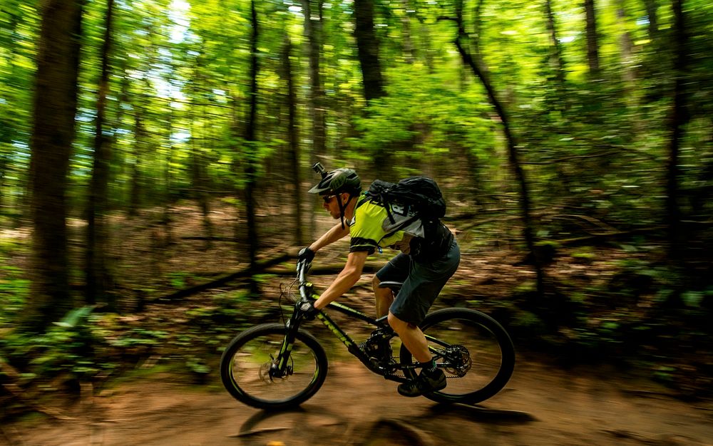 Aron Smith mountain bikes through the Pisgah National Forest, NC. (Forest Service photo by Cecilio Ricardo). Original public…