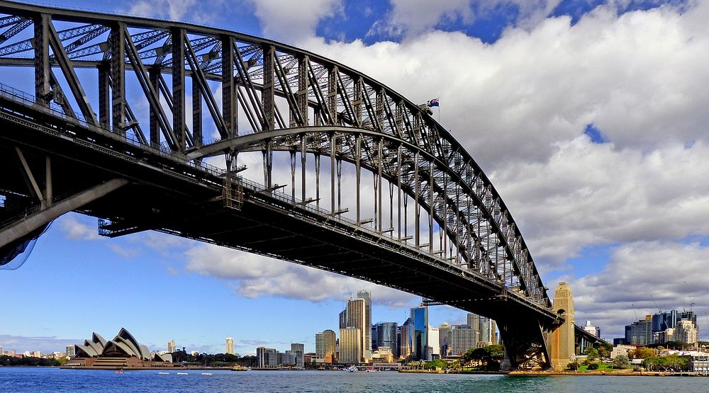 The Sydney Harbour Bridge is a steel through arch bridge across Sydney Harbour that carries rail, vehicular, bicycle, and…