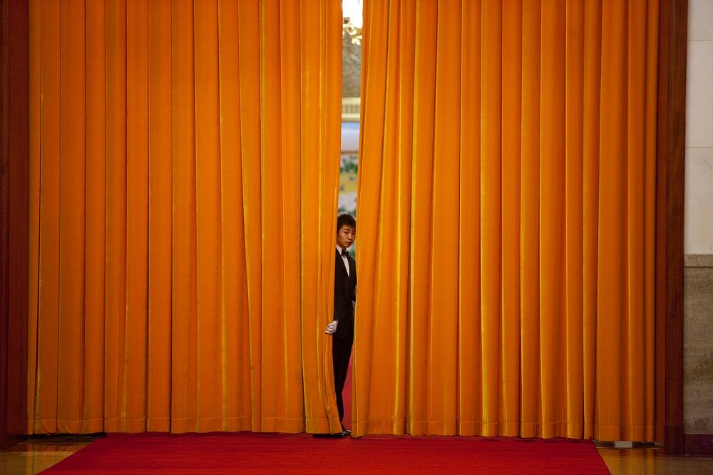Chinese staff prepare for the arrival of President Barack Obama before the official welcoming ceremony at the Great Hall of…