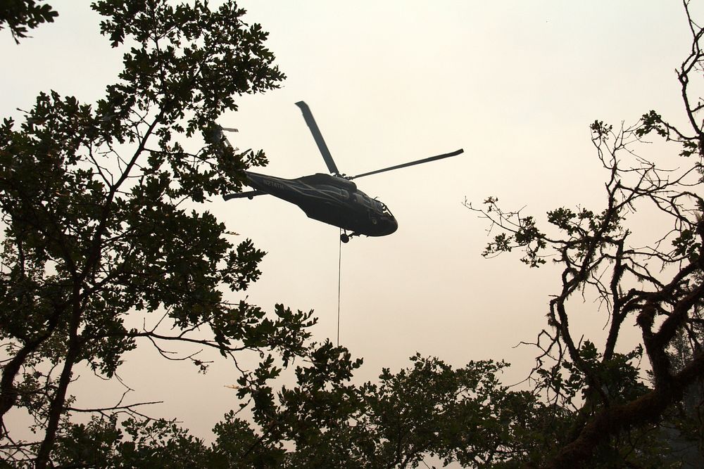Helicopter Operations collecting water from a popular swimming hole near Shan Creek to suppress the Taylor Creek Fire.…