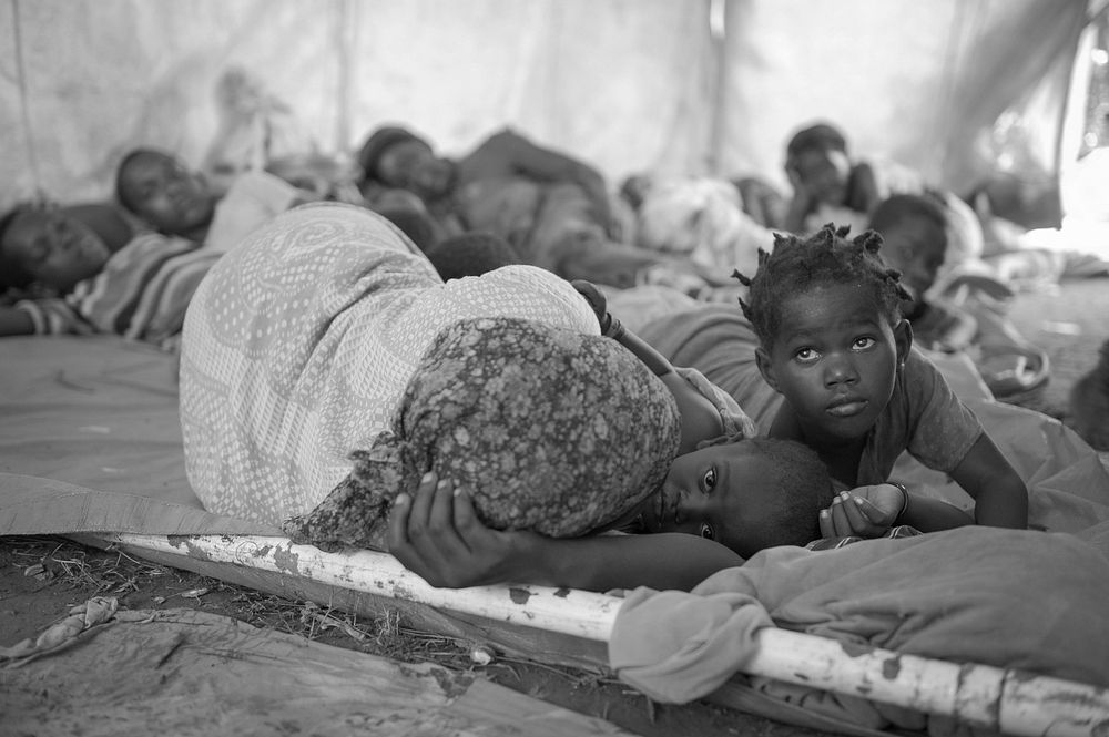 Women and children sleep in a makeshift hospital erected at an AMISOM military camp to help those affected by recent…
