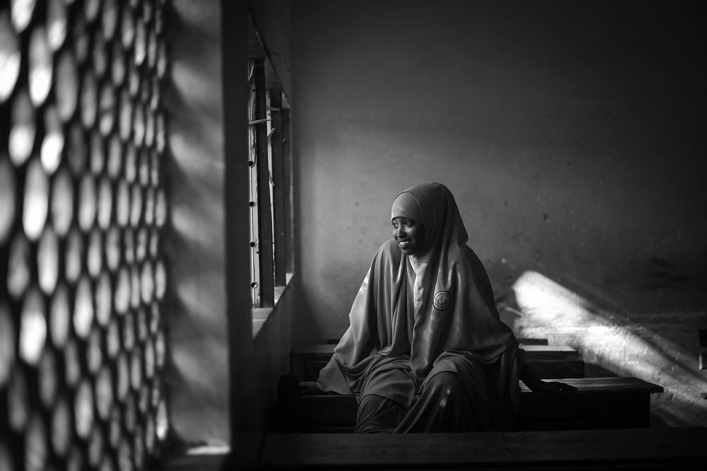 A young schoolgirl looks out of her classroom window at a school assembly in Mogadishu, Somalia, on August 29, 2017. UN…