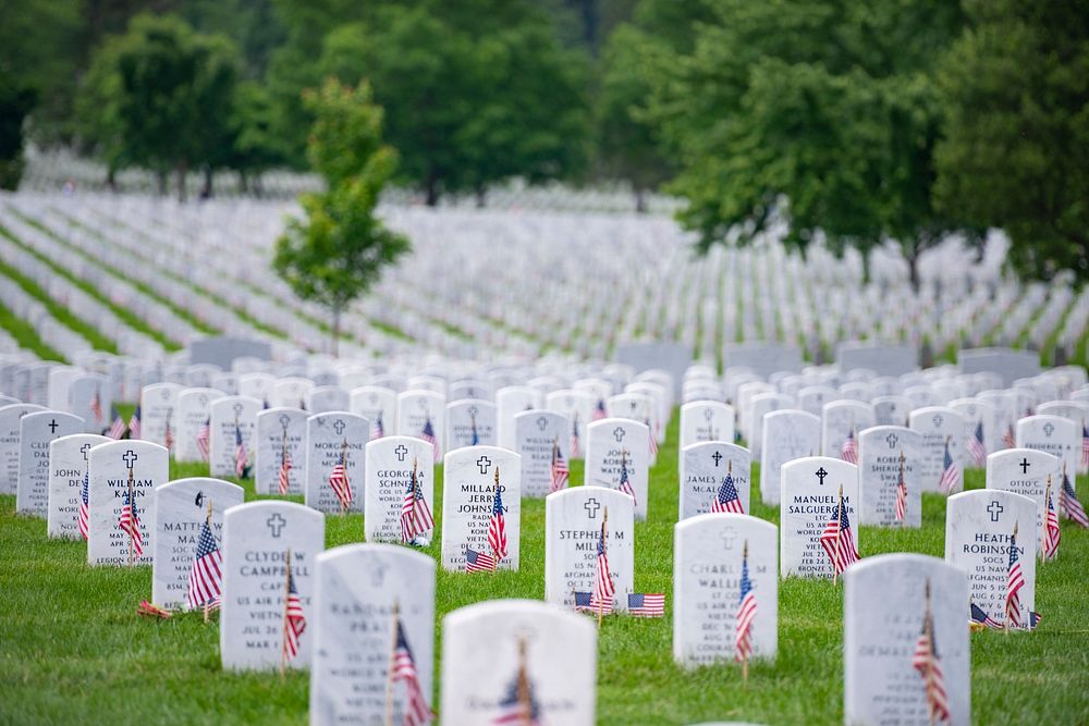 Flags, flowers and other mementos adorn headstones in Section 60 of Arlington National Cemetery, Arlington, Virginia, May…