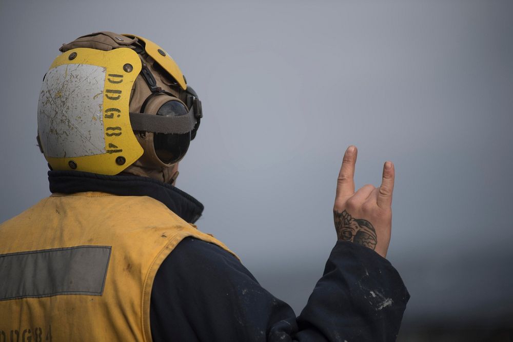 ATLANTIC OCEAN (Sept. 3, 2018) Boatswain's Mate 3rd Class Neylon Curley acts as landing signalman aboard the Arleigh Burke…