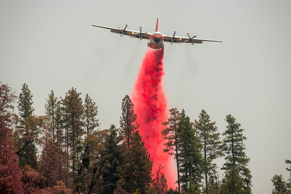 A Forest Service C-130 MAFFS airtanker making a retardant drop above Jerseydale; Ferguson Fire, Sierra NF, CA, 2018.…