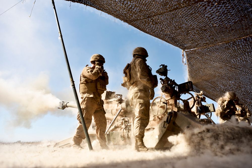 Marines with Mike Battery, 3rd Battalion, 11 Marine Regiment, 1st Marine Division, fire an M777 Howitzer at known targets…
