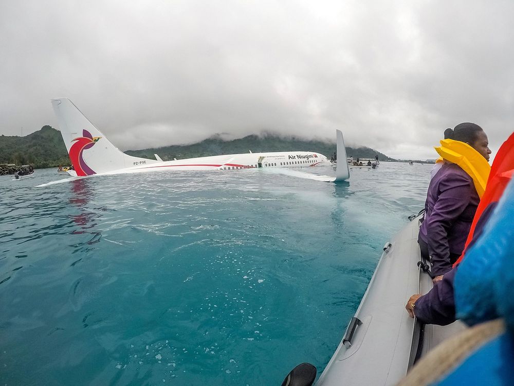 U.S. Sailors assigned to Underwater Construction Team (UCT) 2 assist local authorities in rescuing the passengers and crew…